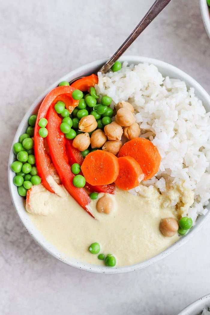 creamy cashews curry and veggies in a bowl with rice