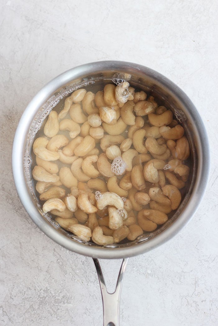 cashews in a sauce pan ready to be flash boiled