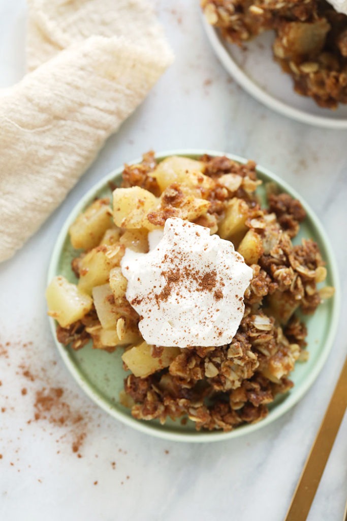 This delicious apple crisp recipe is made with a simple apple filling and a delicious crumble topping. Make this healthier, fall-inspired dessert today! crisp on plate