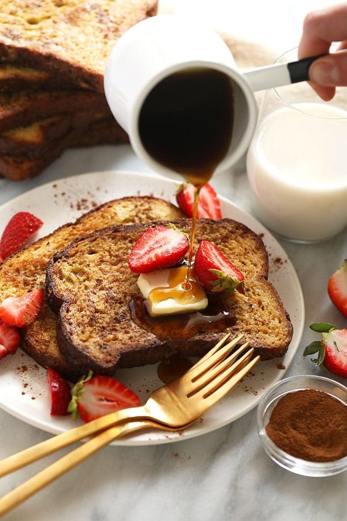 sheet pan french toast on a plate drizzled with maple syrup