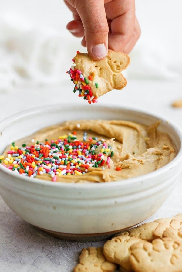 Mixing peanut butter with sprinkles to create a Cake Batter Dip.