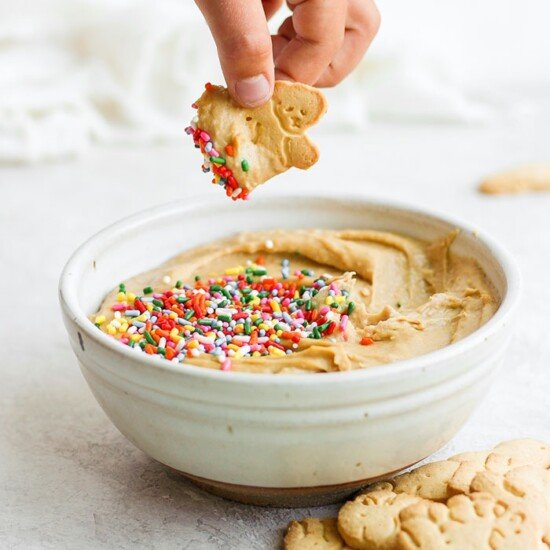 A bowl of peanut butter hummus topped with sprinkles.