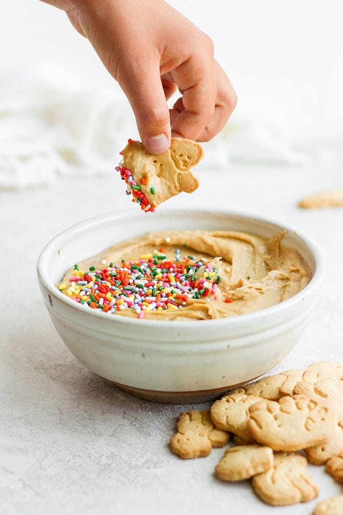 Animal crackers dipped into cake batter dip