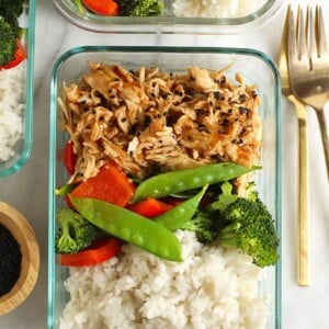 a crock pot dish with teriyaki chicken served over rice, broccoli, and carrots.