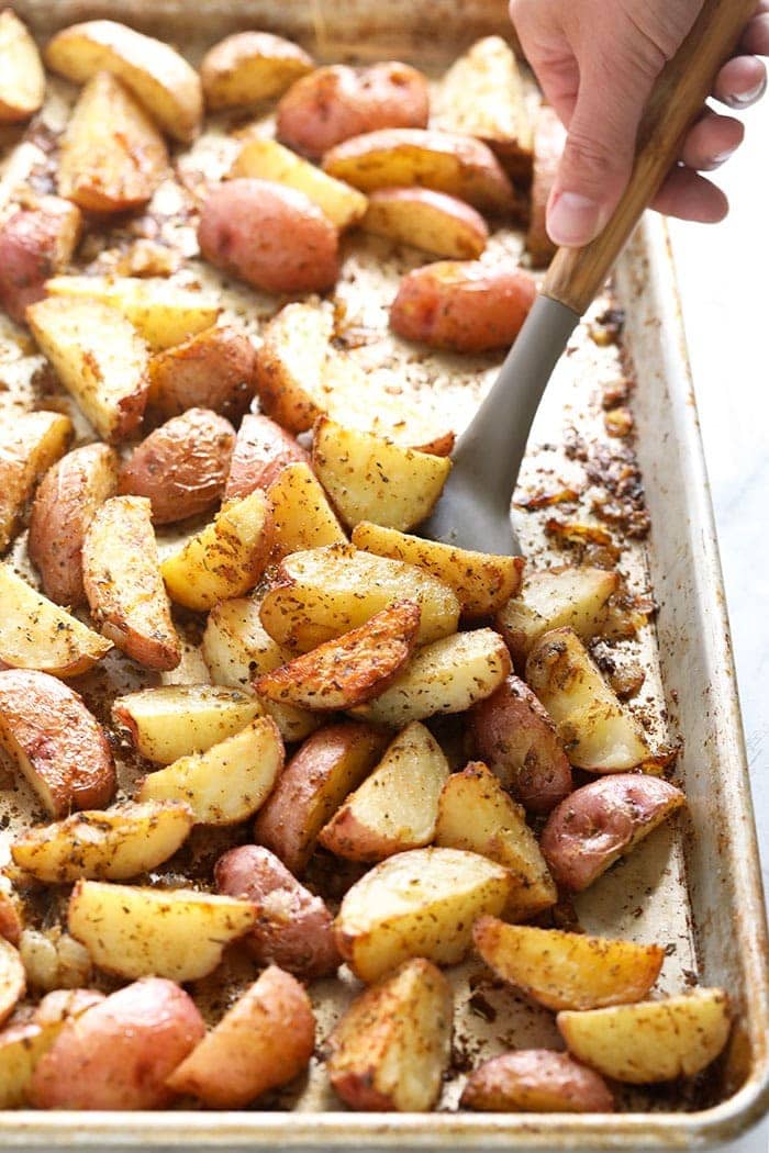 Tossing red potatoes on a pan