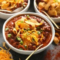 Three bowls of the best chili, served with tortilla chips.
