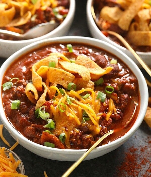 Three bowls of the best chili, served with tortilla chips.