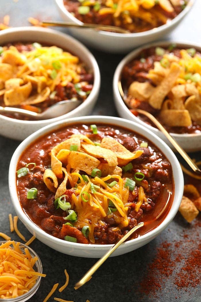 4 bowls of beef chili with Fritos on top