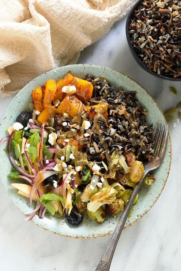 The Vegetarian Grain Bowl that screams all things harvest season! Perfect for meal prep, or serving a group, this vegetarian harvest grain bowl is about to be your Fall favorite. vegetarian harvest grain bowl with tahini dressing in a bowl