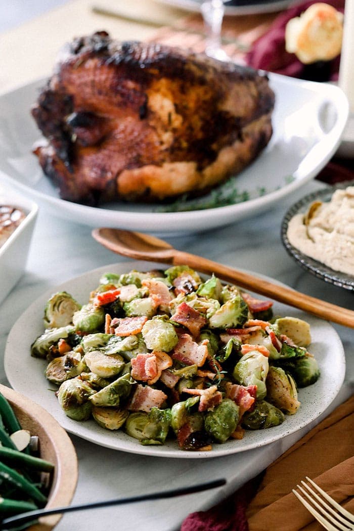 roasted brussels sprouts in bowl on table with turkey