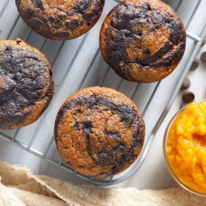 chocolate pumpkin zucchini muffins on a cooling rack