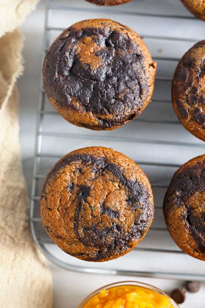 chocolate pumpkin zucchini muffins on a cooling rack