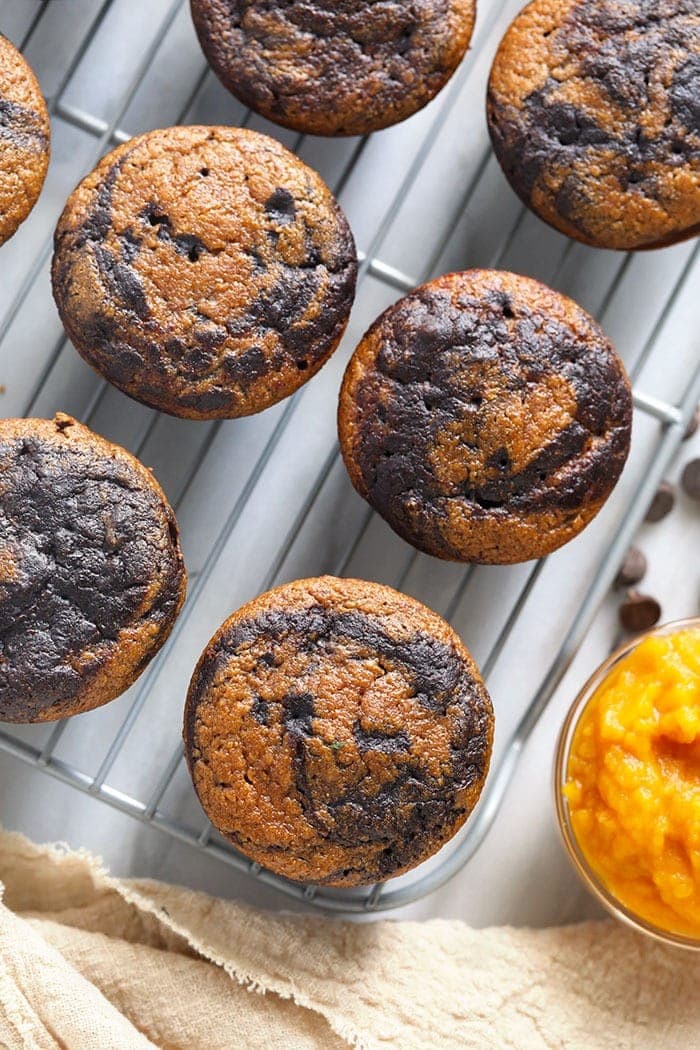 chocolate pumpkin zucchini muffins on a cooling rack