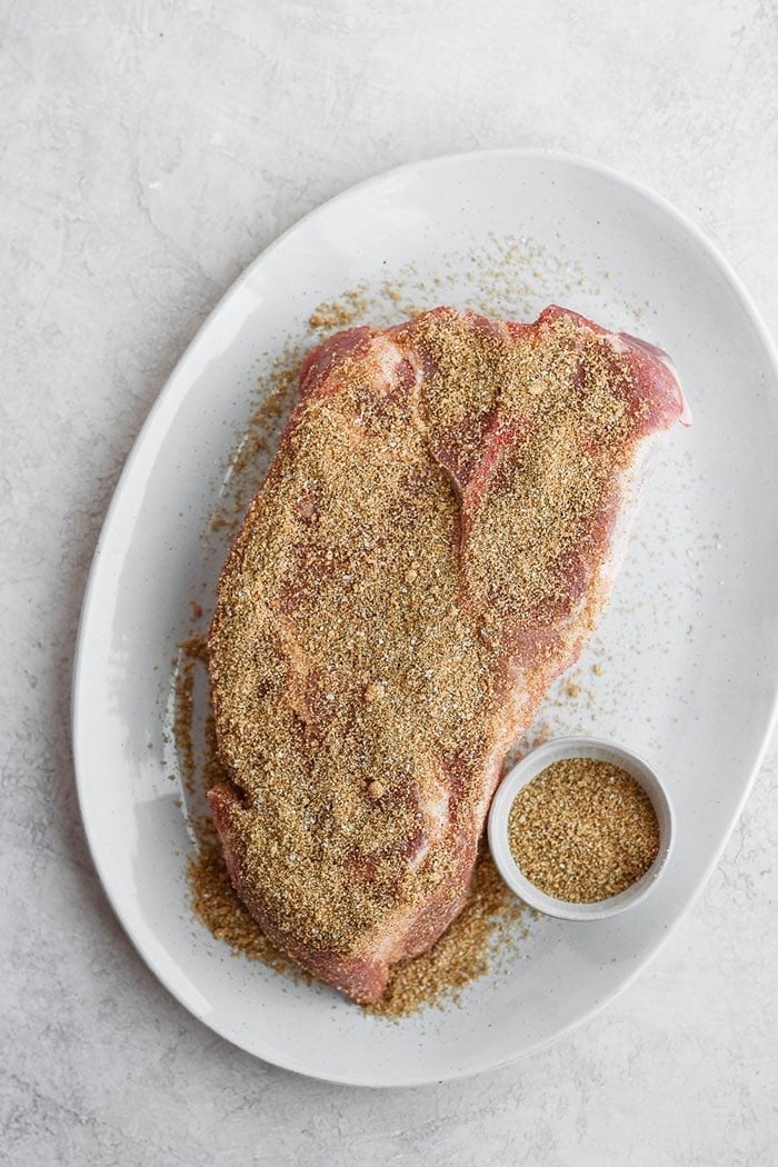 Whether you're making pork chops, ribs, pork shoulder, or a pork tenderloin you'll love this all-purpose dry rub for pork. dry rub for pork on a plate