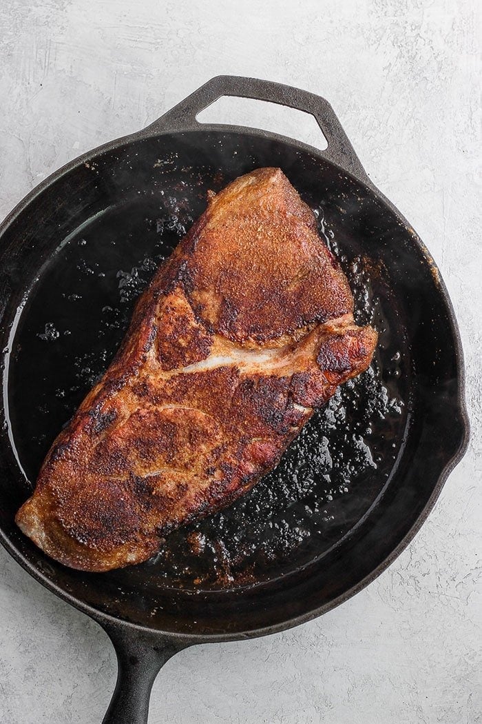 dry rubbed pork in a cast iron skillet