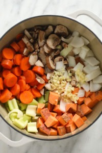 A white bowl filled with a savory Sweet Potato Lentil Stew.