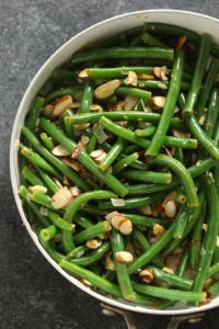 Green beans almondine cooked in a skillet.