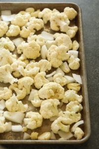 Cauliflower florets on a baking sheet, perfect for making cauliflower mashed potatoes.