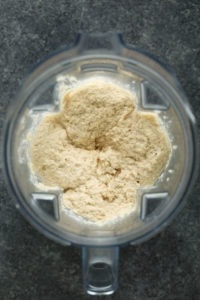 A bowl of cauliflower mashed potatoes in a food processor.