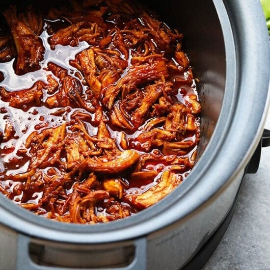 a slow cooker full of honey sriracha pulled pork.