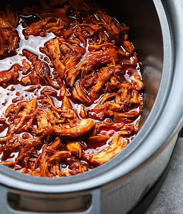 a slow cooker full of honey sriracha pulled pork.