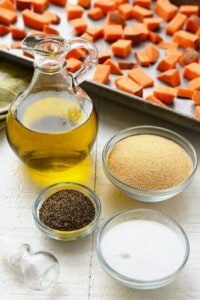 Sweet potatoes with oil, salt, and spices on a table.