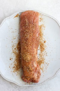 Sous vide pork tenderloin served with spices on a plate.