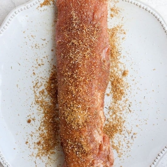 Sous vide pork tenderloin served with spices on a plate.