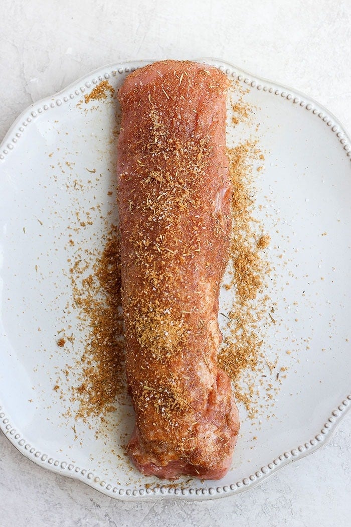 Seasoned pork tenderloin on a plate. 