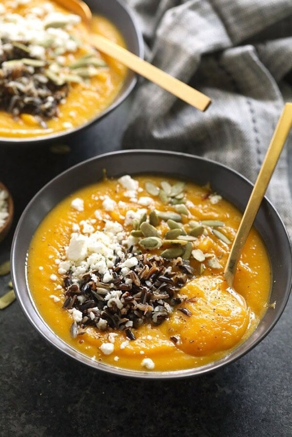 instant pot butternut squash soup in a bowl topped with wild rice and goat cheese