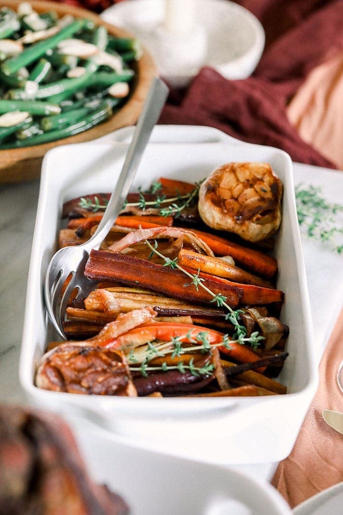roasted carrots and garlic plated at a holiday table