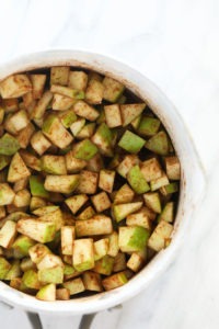 Sliced apples arranged in a white bowl, perfect for making apple pie bars.