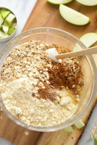 Apple pie bars with oats, oat bran, cinnamon and apples elegantly displayed on a cutting board.