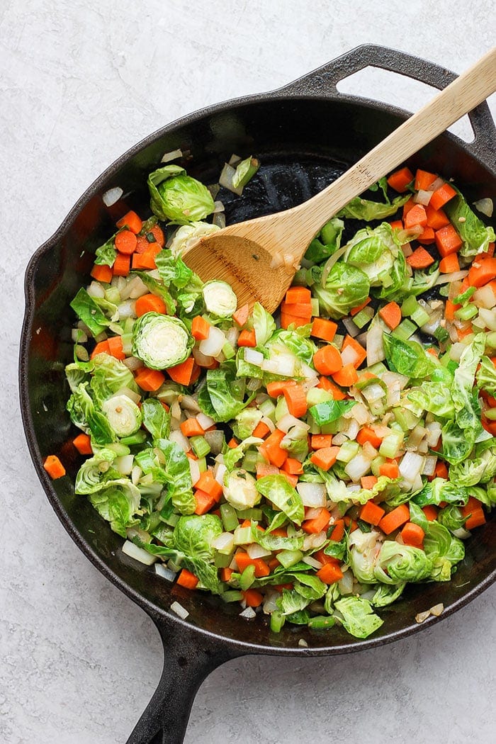 sauteed veggies in a skillet for cornbread stuffing
