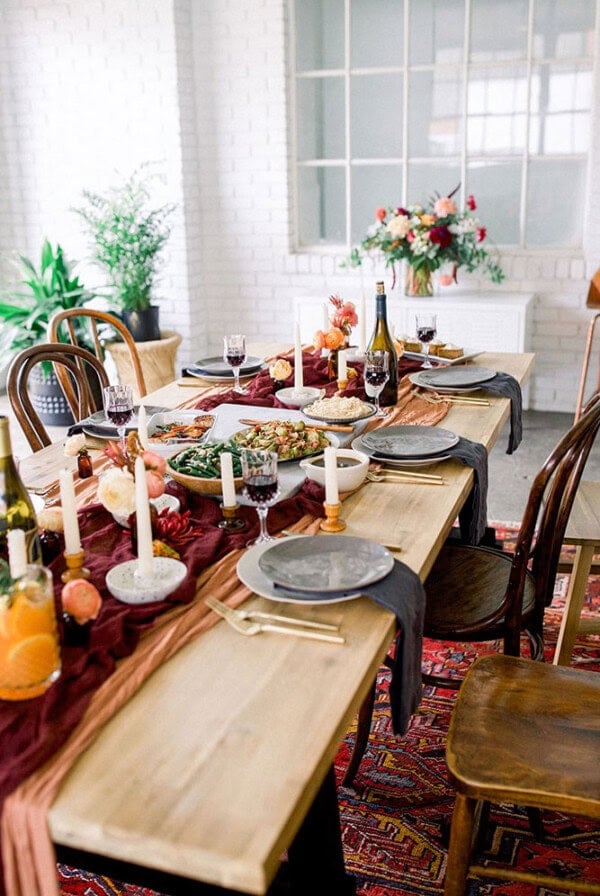 Thanksgiving table setting in a dining room, friendsgiving style.