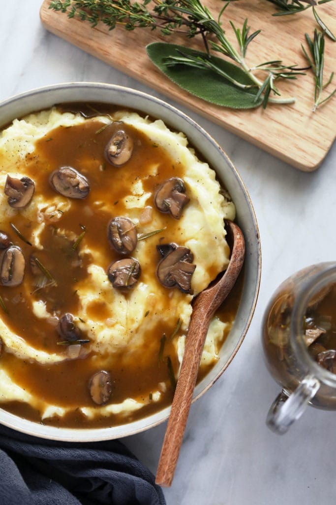 Mushroom gravy over mashed potatoes in a bowl. 
