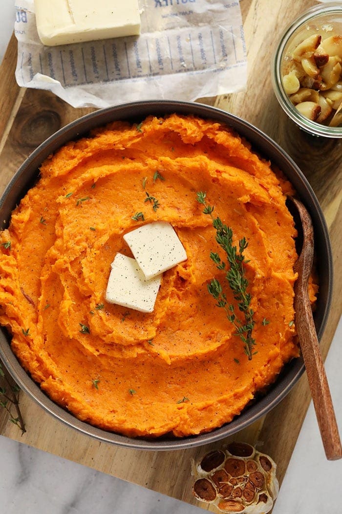 healthy mashed sweet potatoes in bowl with butter 
