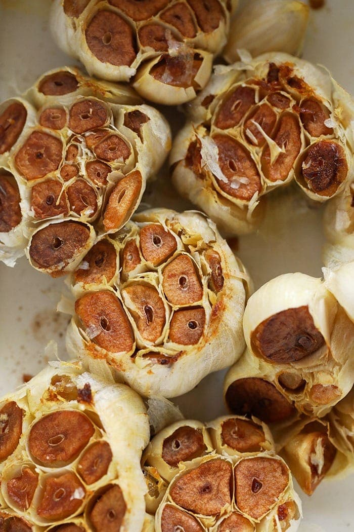 roasted garlic cloves in a baking dish