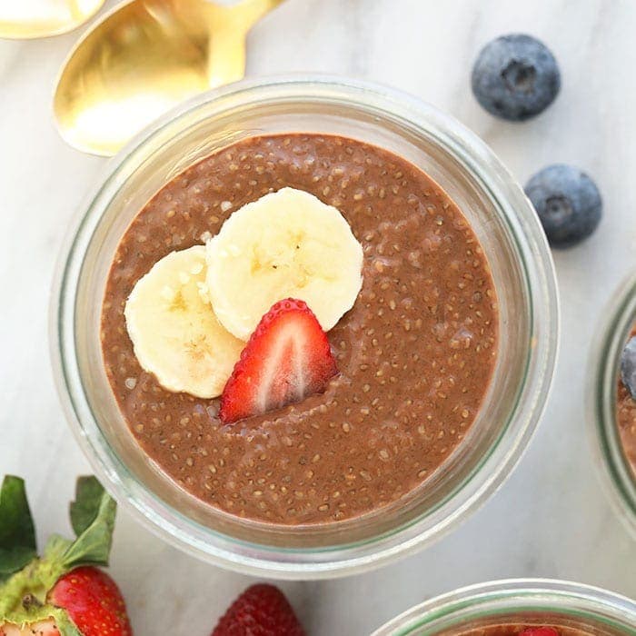 Three jars of protein-packed chia seed pudding with berries and bananas.