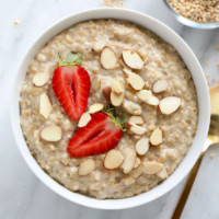 A healthy breakfast idea consisting of oatmeal topped with strawberries and almonds.