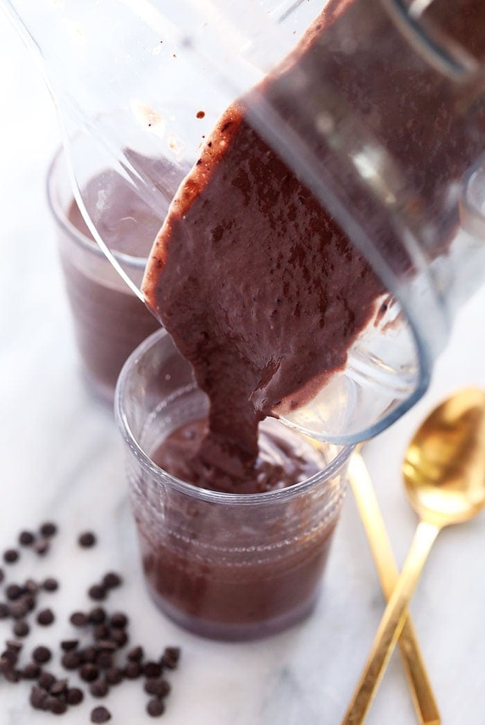 Blended protein shake being poured into a glass