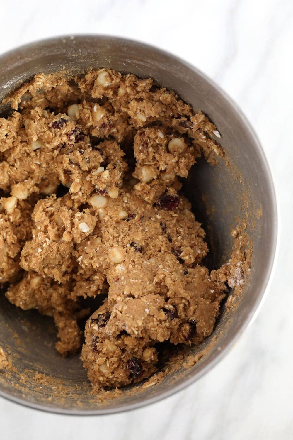 white chocolate cranberry oatmeal cookie batter in a bowl