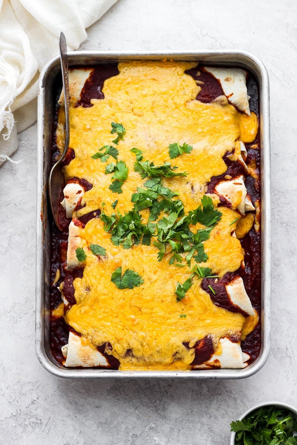 pan of enchiladas with cheese on top