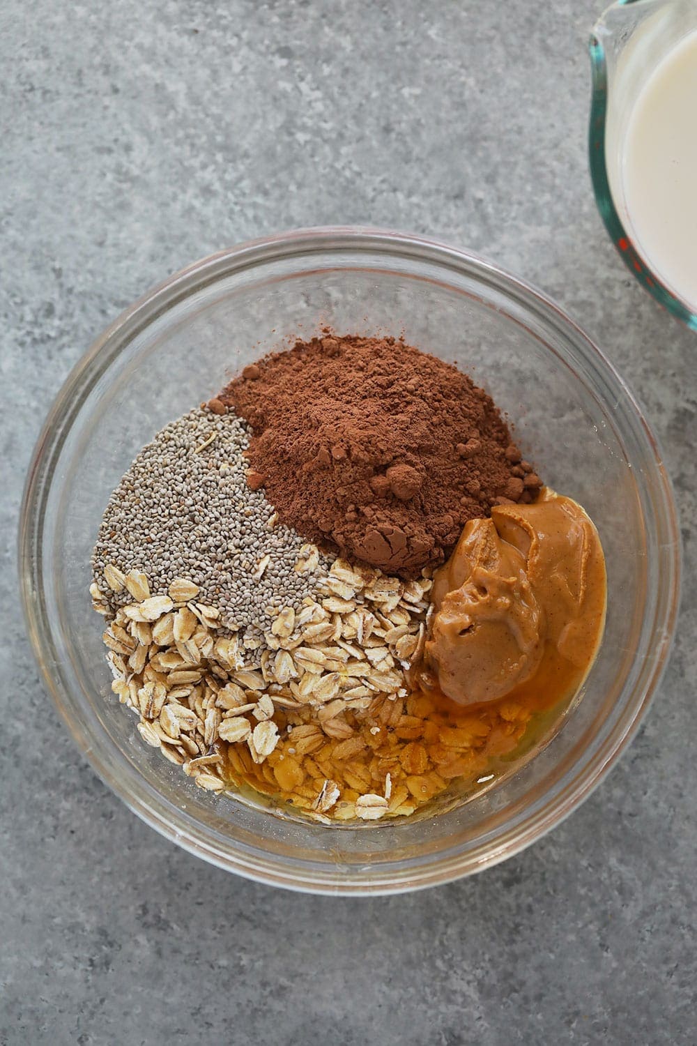 chocolate peanut butter overnight oats ingredients in a bowl.