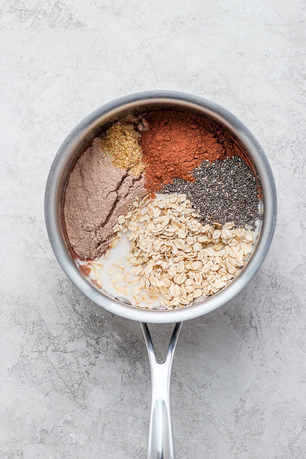 chocolate sea salt protein oatmeal ingredients in a pot ready to be cooked
