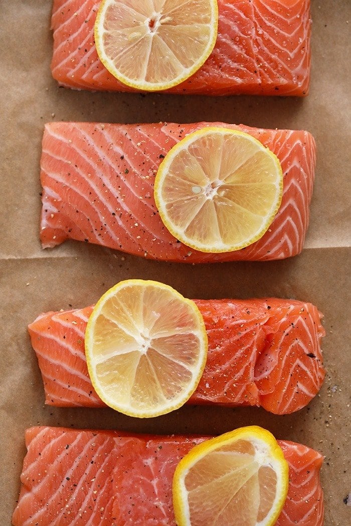 salmon filets with lemon wedges