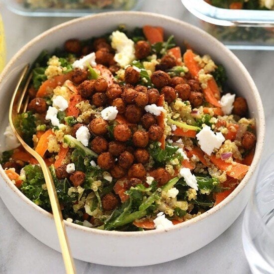 a bowl of quinoa salad with kale and carrots.