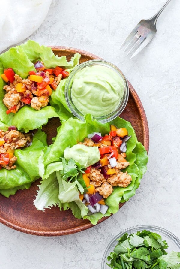 Chicken lettuce wraps served with guacamole.