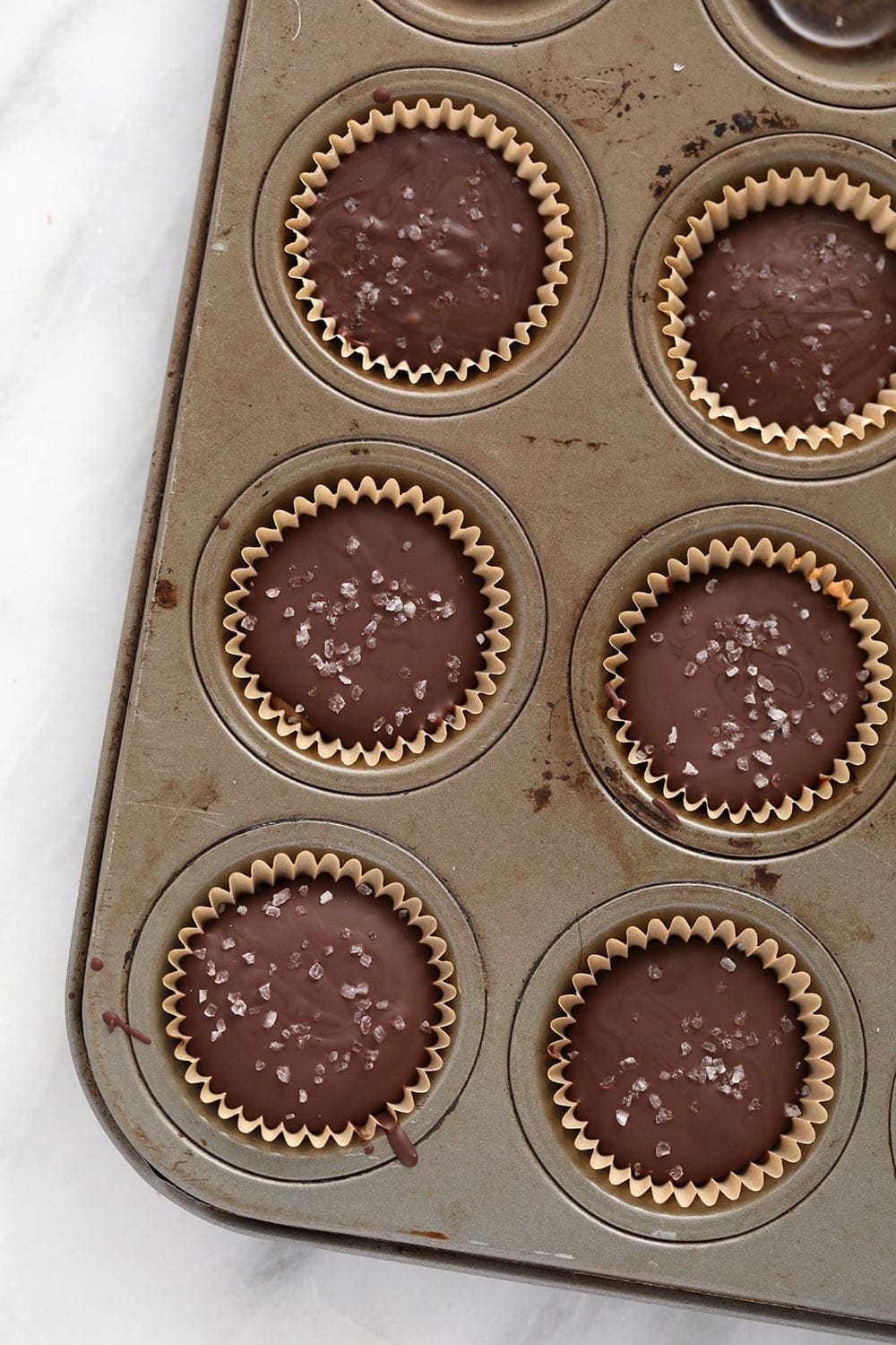 almond butter cups in muffin tin