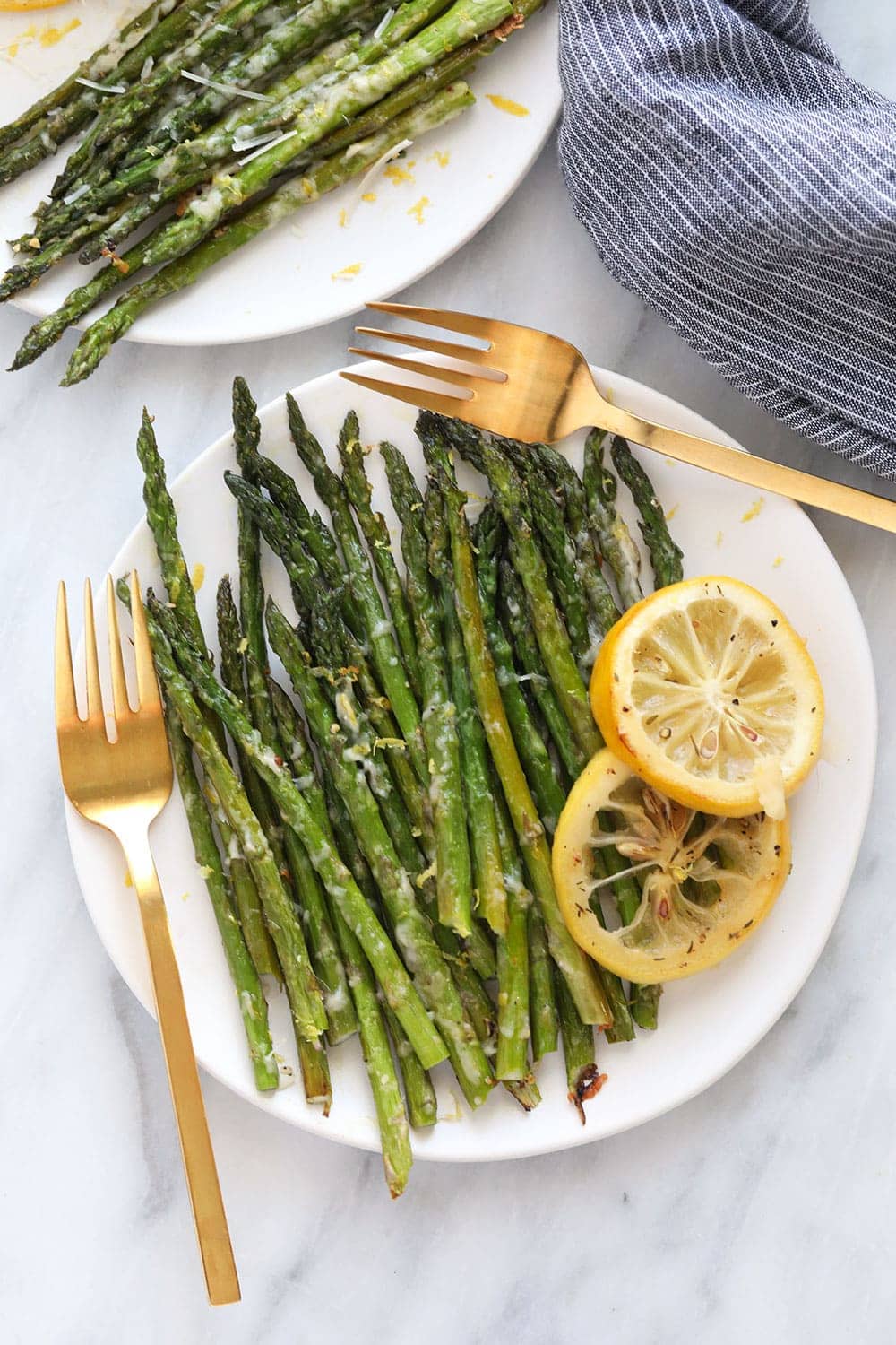 Asparagus on plate with lemon zest garnish. 